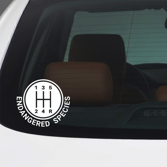 White Endangered Species 5-speed manual gear shifter vinyl sticker applied to a car window.