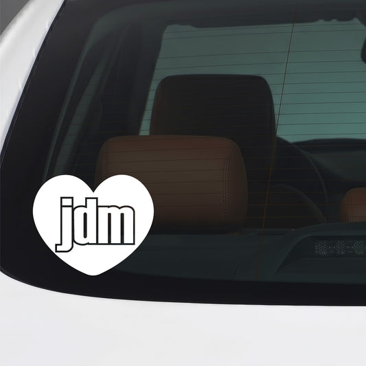 White JDM heart sticker applied to a car window.
