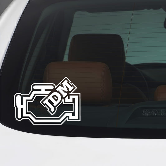 White JDM engine block vinyl sticker applied to a car window.