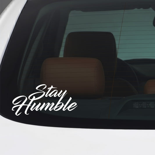 White Stay Humble sticker applied to a car window.