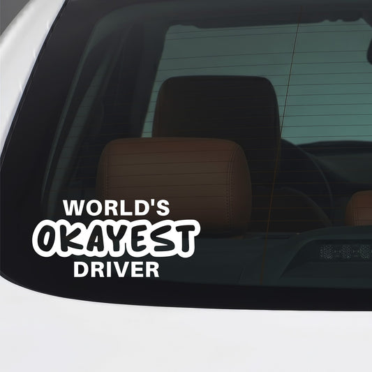 White Worlds Okayest Driver sticker applied to a car window.