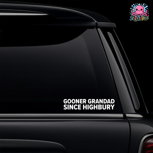 Car window with a decal reading 'GOONER GRANDAD SINCE Highbury' on a black background.