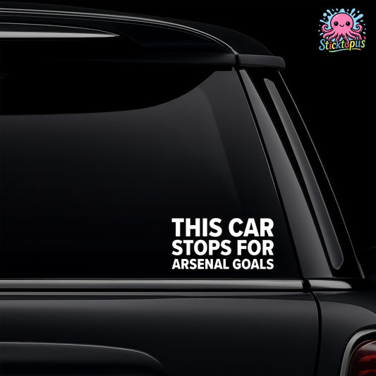Car window with a decal saying 'This car stops for Arsenal goals' on a black background.