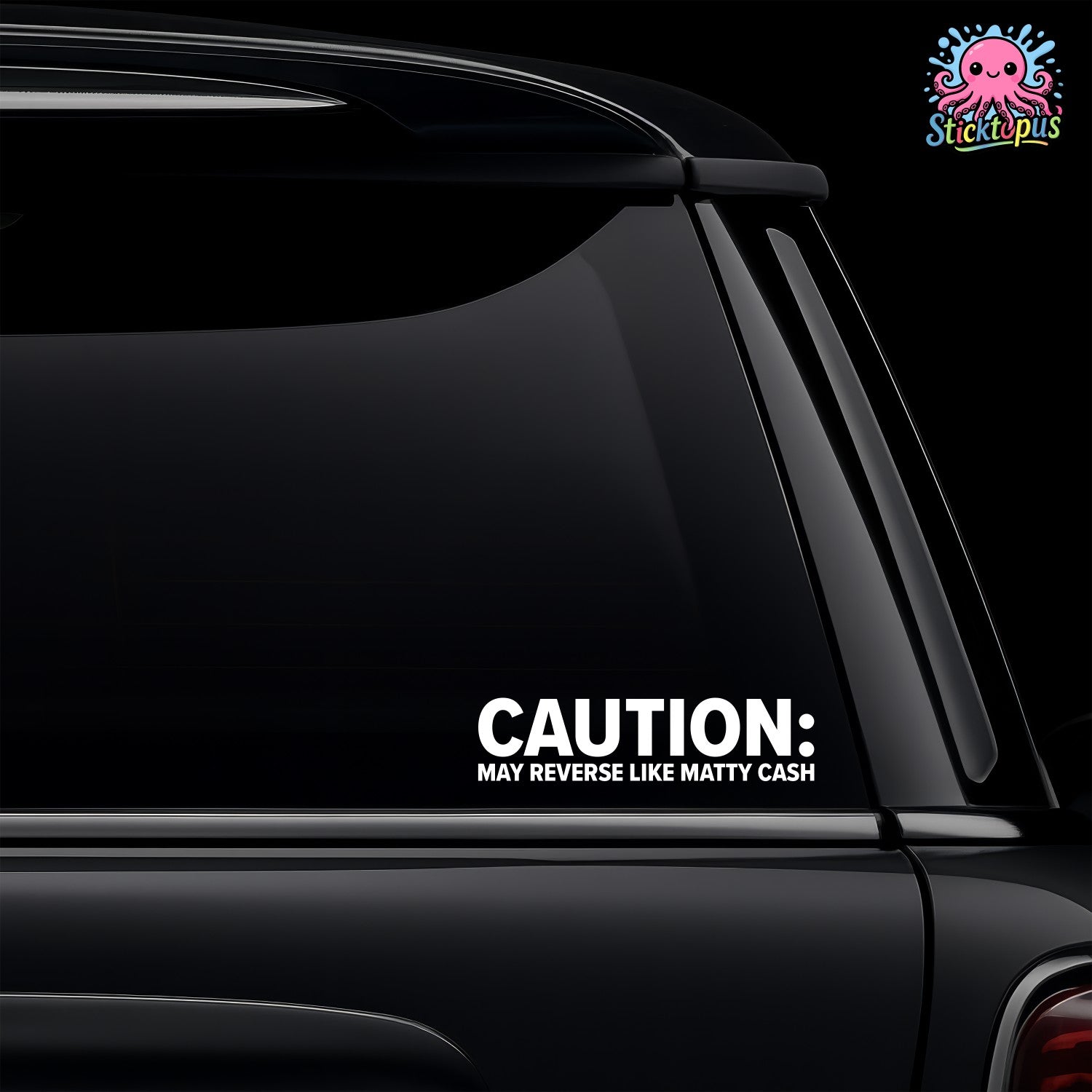 Car window with a decal reading 'CAUTION: MAY REVERSE LIKE MATTY CASH' on a black background.