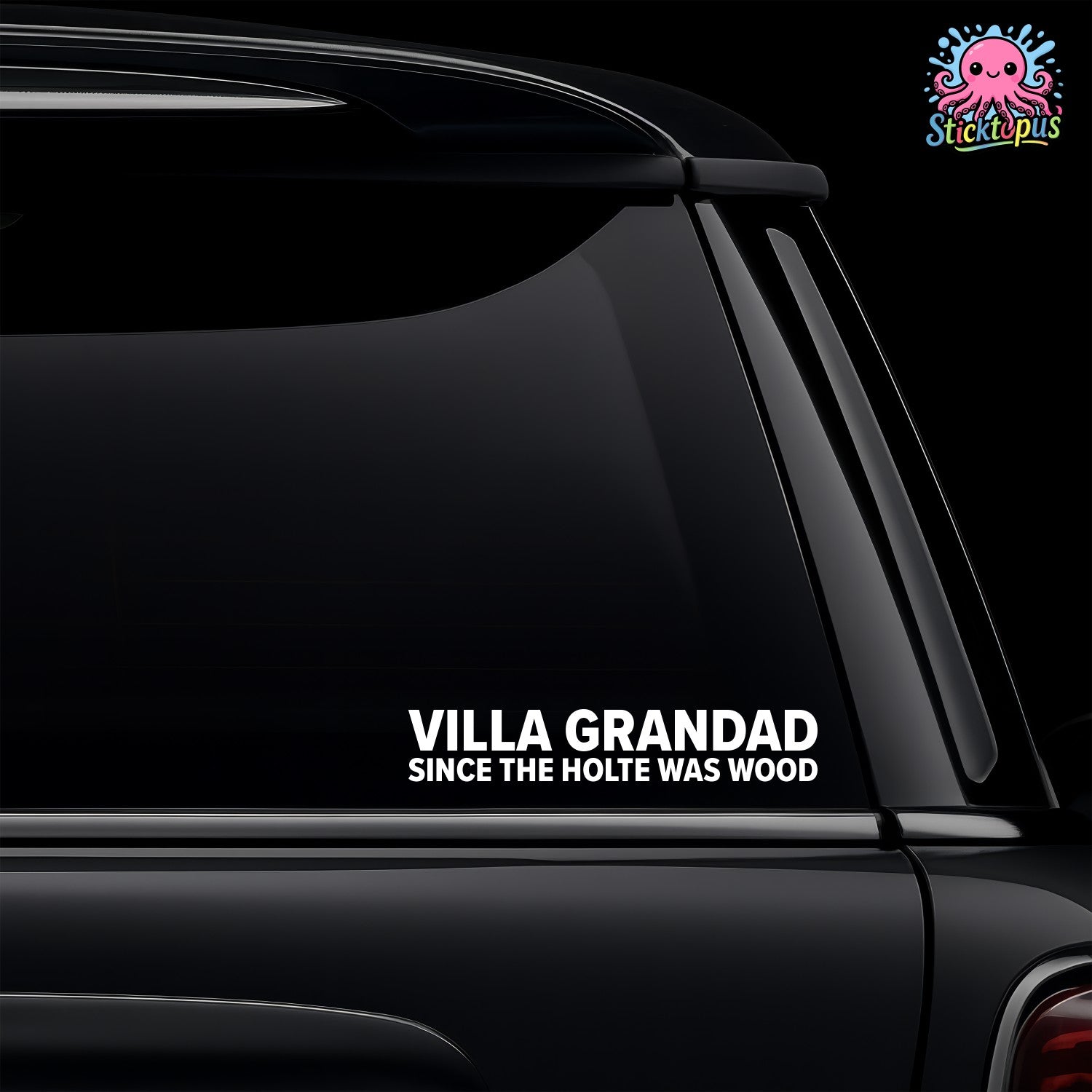 Car window with a humorous decal reading 'Villa Grandad since the Holte was wood' on a black background.