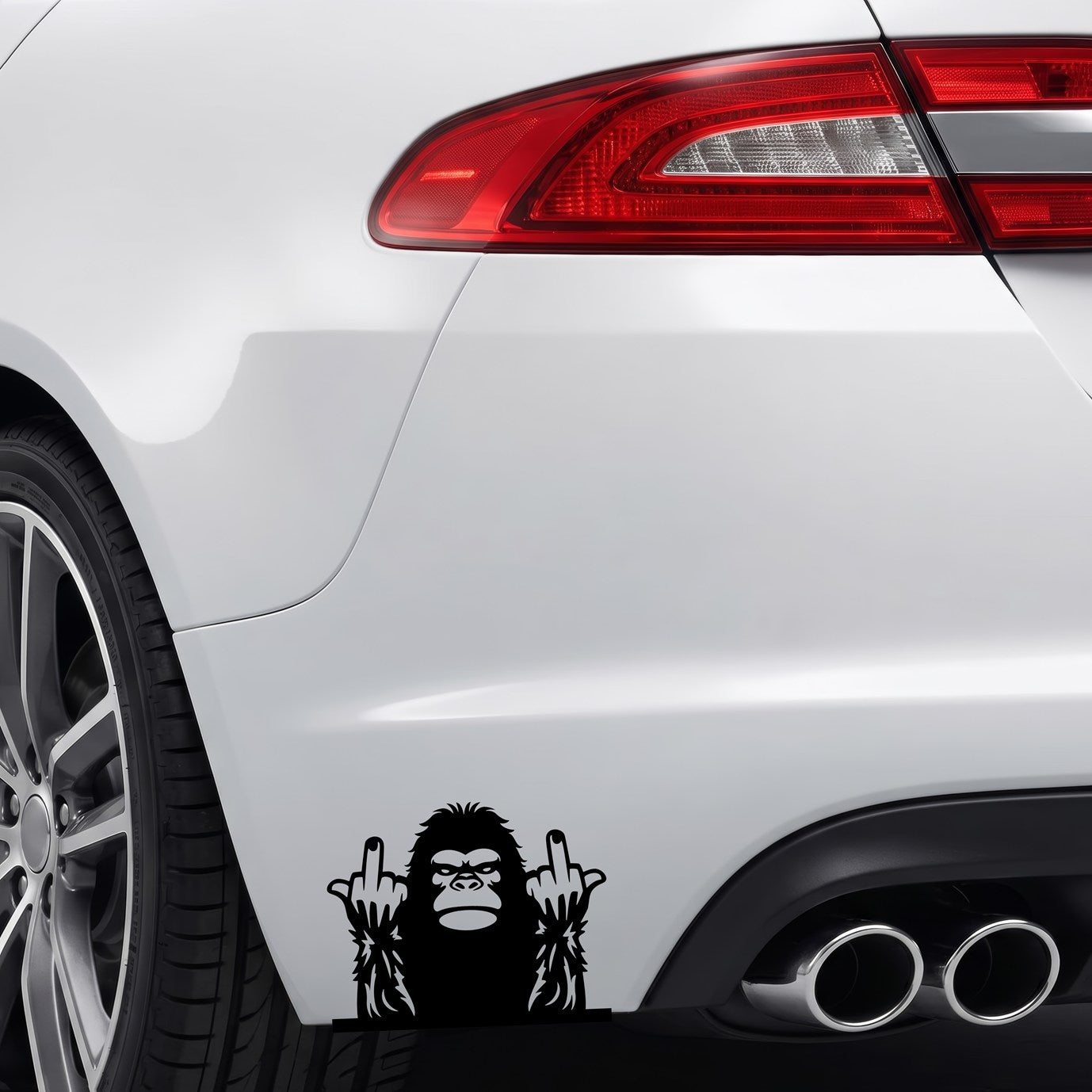 Black Bigfoot middle fingers vinyl sticker applied to a car rear bumper.