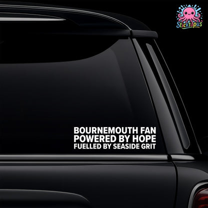 Car window with a decal reading 'Bournemouth Fan Powered by Hope Fuelled by Seaside Grit' on a black background.