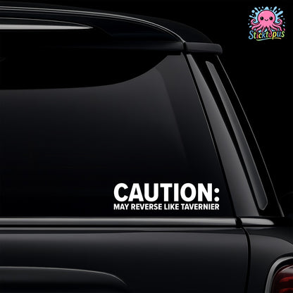 Car window with a humorous decal reading 'CAUTION: MAY REVERSE LIKE TAVERNIER' on a black background.