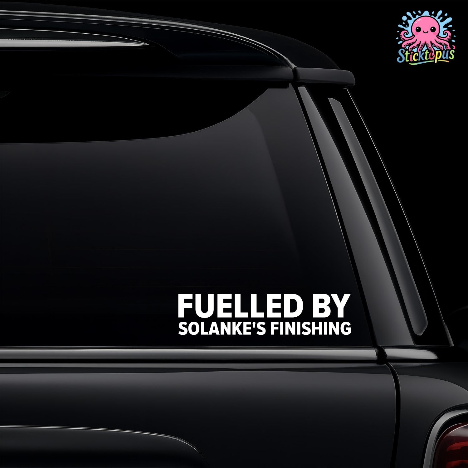 Car window with a decal reading 'Fueled by Solanke's Finishing' on a black background.