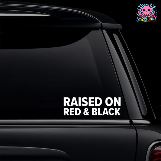 Car window with 'Raised on Red & Black' decal and Sticktopus logo.