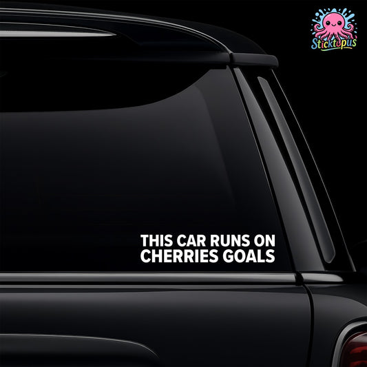 Car window with a humorous decal reading 'This car runs on cherries goals' and the brand 'Sticktopus' logo.