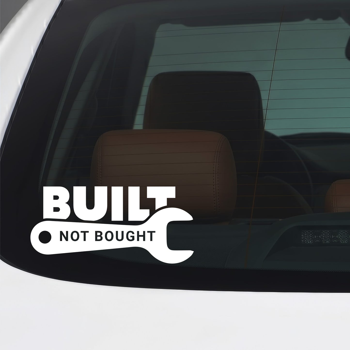 White Built Not Bought sticker applied to a car window.