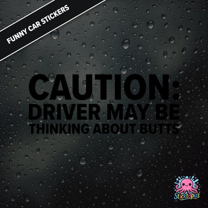 Caution: Driver May Be Thinking About Butts — cheeky caution sticker in black text, surreal distraction warning.