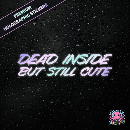 Premium holographic sticker with the phrase “DEAD INSIDE BUT STILL CUTE” in bold, pastel-shifting text on a black background with water droplets.