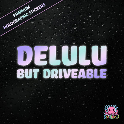 Premium holographic sticker with the phrase “DELULU BUT DRIVEABLE” in bold, pastel-shifting text on a black background with water droplets.