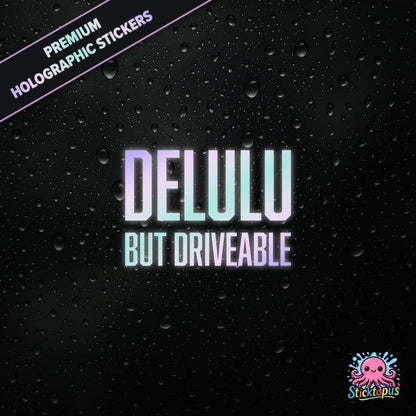 Premium holographic sticker with the phrase “DELULU BUT DRIVEABLE” in bold, pastel-shifting text on a black background with water droplets.