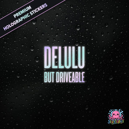 Premium holographic sticker with the phrase “DELULU BUT DRIVEABLE” in bold, pastel-shifting text on a black background with water droplets.