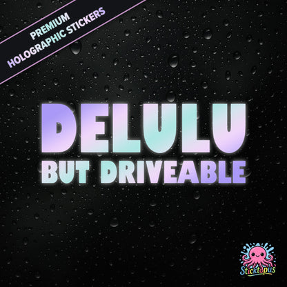 Premium holographic sticker with the phrase “DELULU BUT DRIVEABLE” in bold, pastel-shifting text on a black background with water droplets.