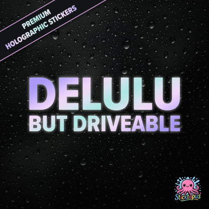 Premium holographic sticker with the phrase “DELULU BUT DRIVEABLE” in bold, pastel-shifting text on a black background with water droplets.