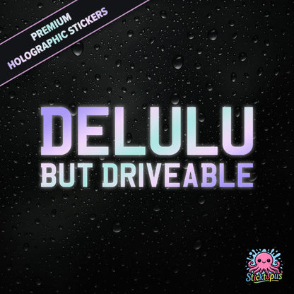 Premium holographic sticker with the phrase “DELULU BUT DRIVEABLE” in bold, pastel-shifting text on a black background with water droplets.