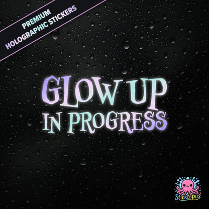 Premium holographic sticker with the phrase “Glow Up in Progress” in bold, pastel-shifting text on a black background with water droplets.