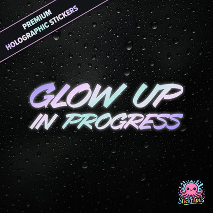 Premium holographic sticker with the phrase “Glow Up in Progress” in bold, pastel-shifting text on a black background with water droplets.