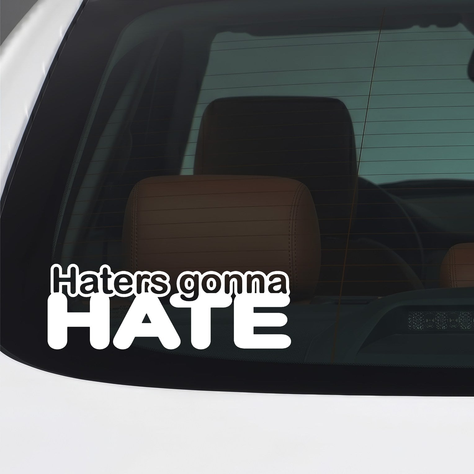 White Haters Gonna Hate sticker applied to a car window.