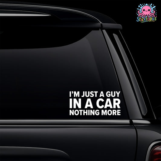 Car window with a humorous decal reading 'I'm just a guy in a car, nothing more' on a black background.