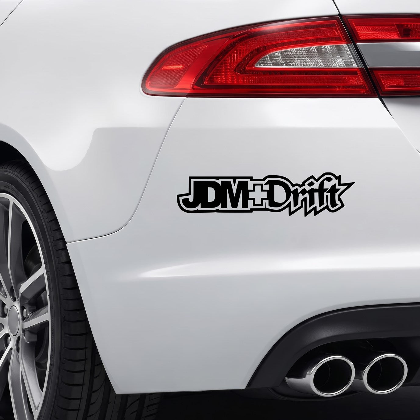Black JDM+Drift vinyl sticker applied to a car rear bumper.