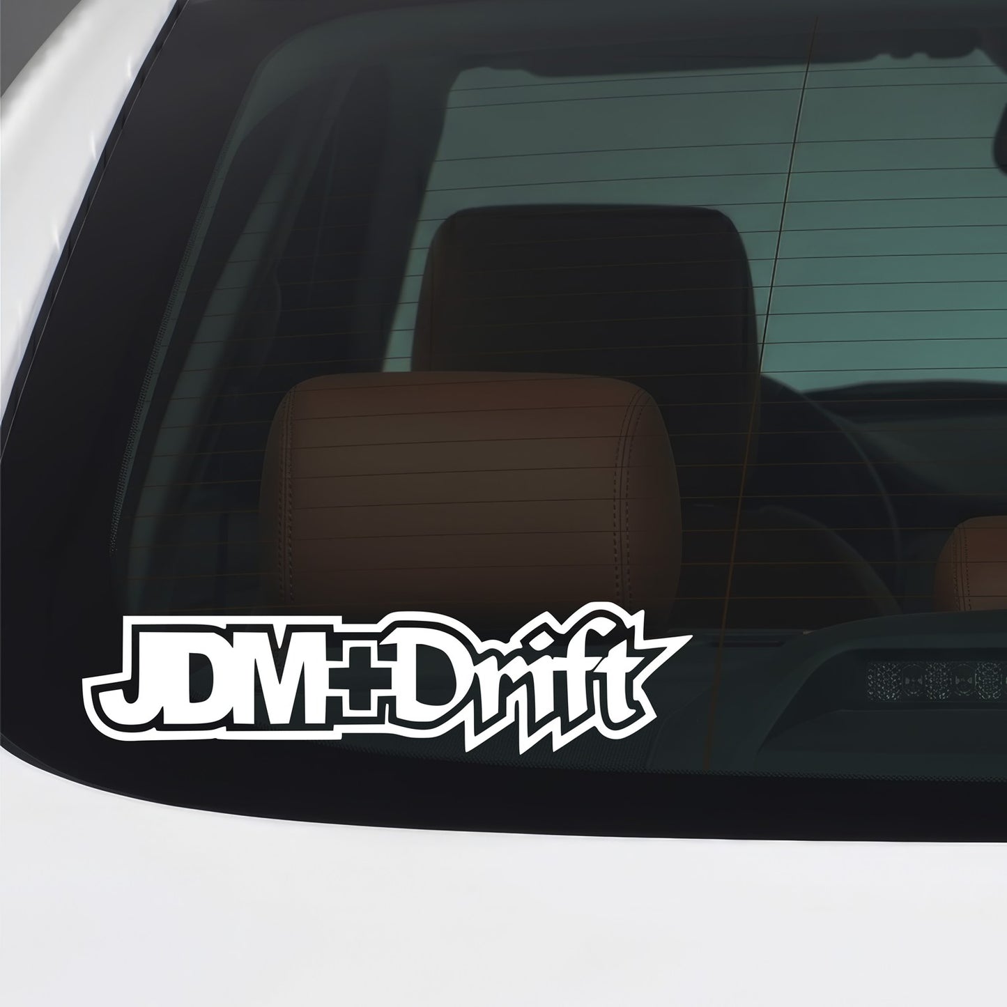 White JDM Drift sticker applied to a car window.