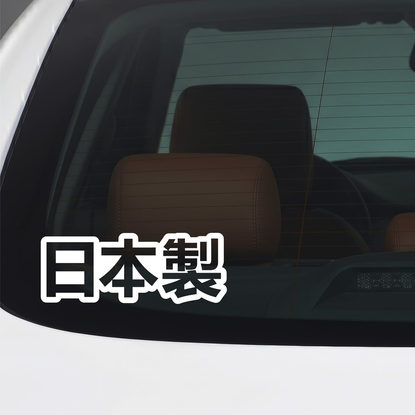 White Made in Japan Nihonsei kanji vinyl sticker applied to a car window.