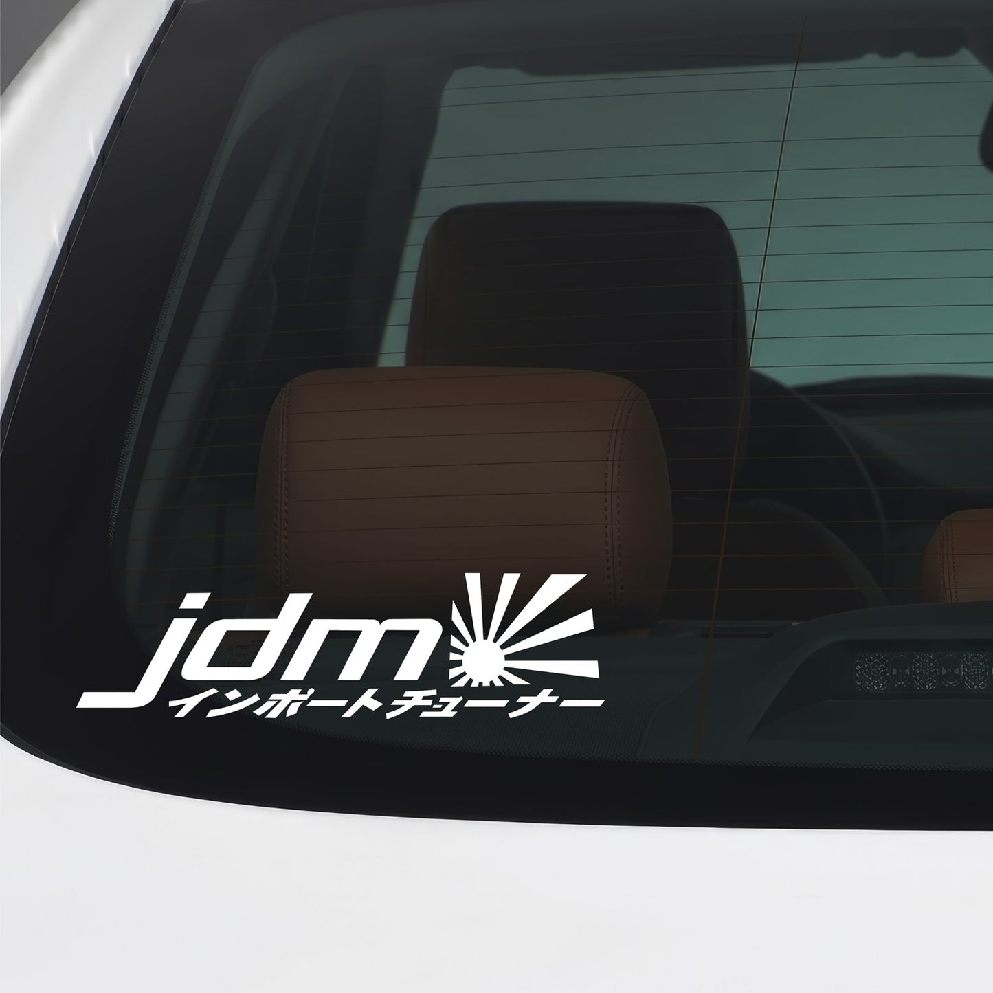 White JDM Rising Sun kanji sticker applied to a car window.