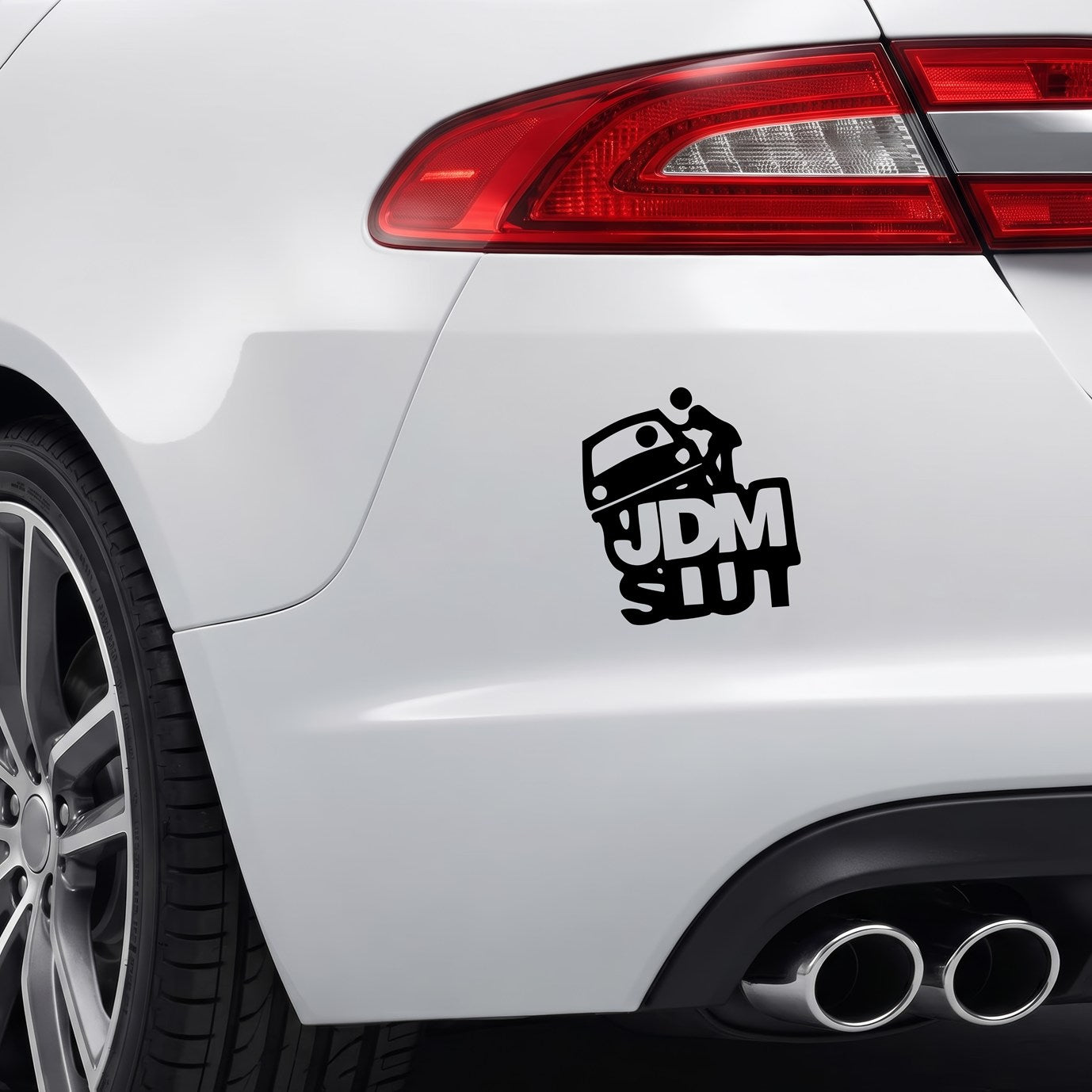 Black JDM Slut vinyl sticker applied to a car rear bumper.