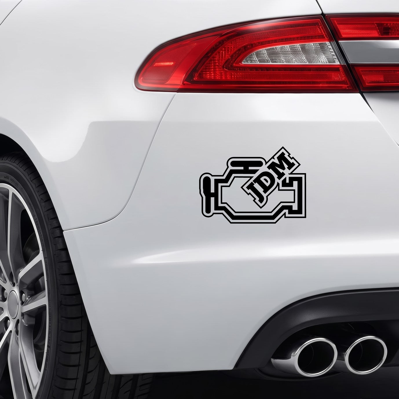 Black JDM engine block sticker applied to a car rear bumper.