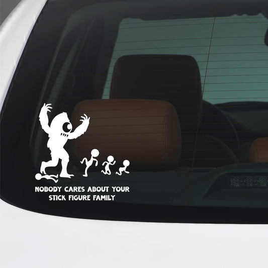 White "Nobody Cares" stick figure family monster sticker applied to a car window.