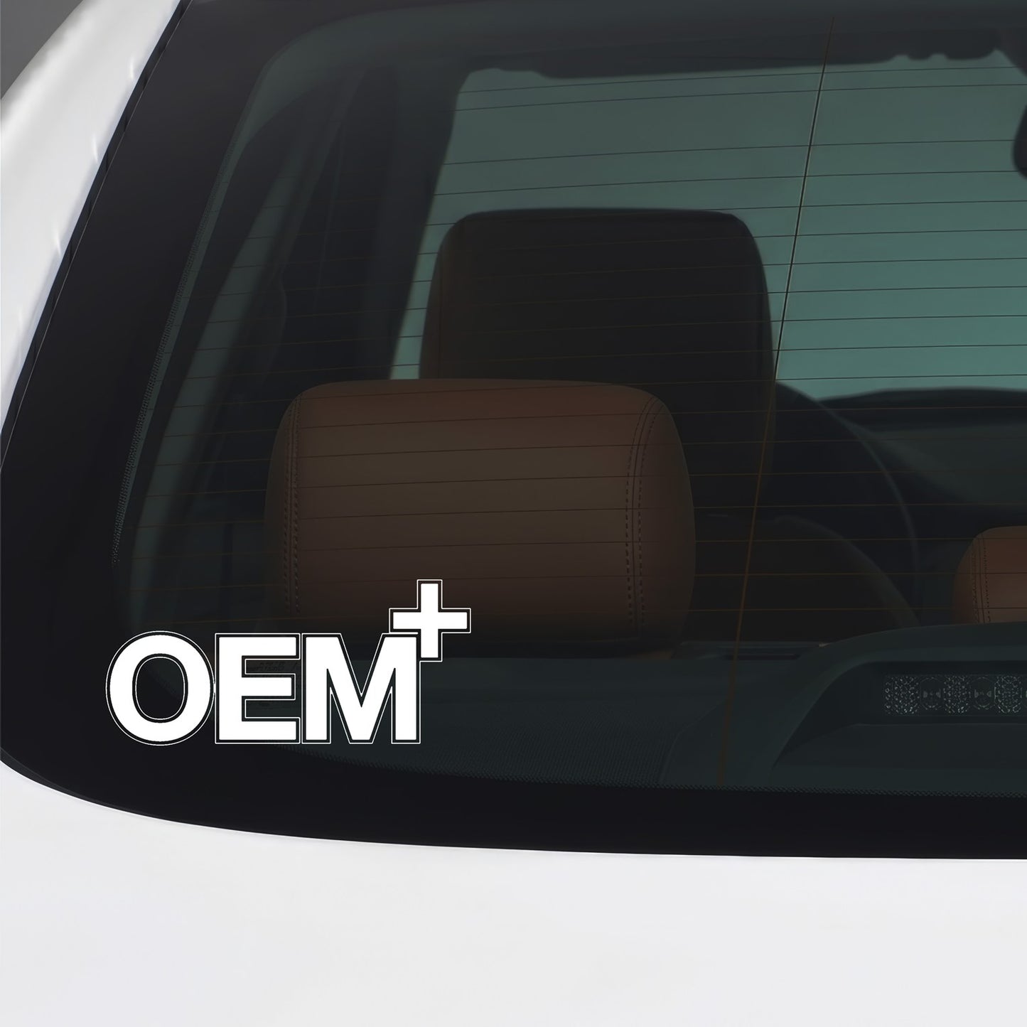 White OEM Plus sticker applied to a car window.