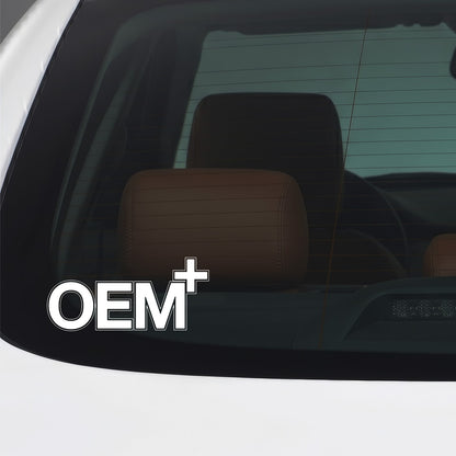 White OEM Plus sticker applied to a car window.