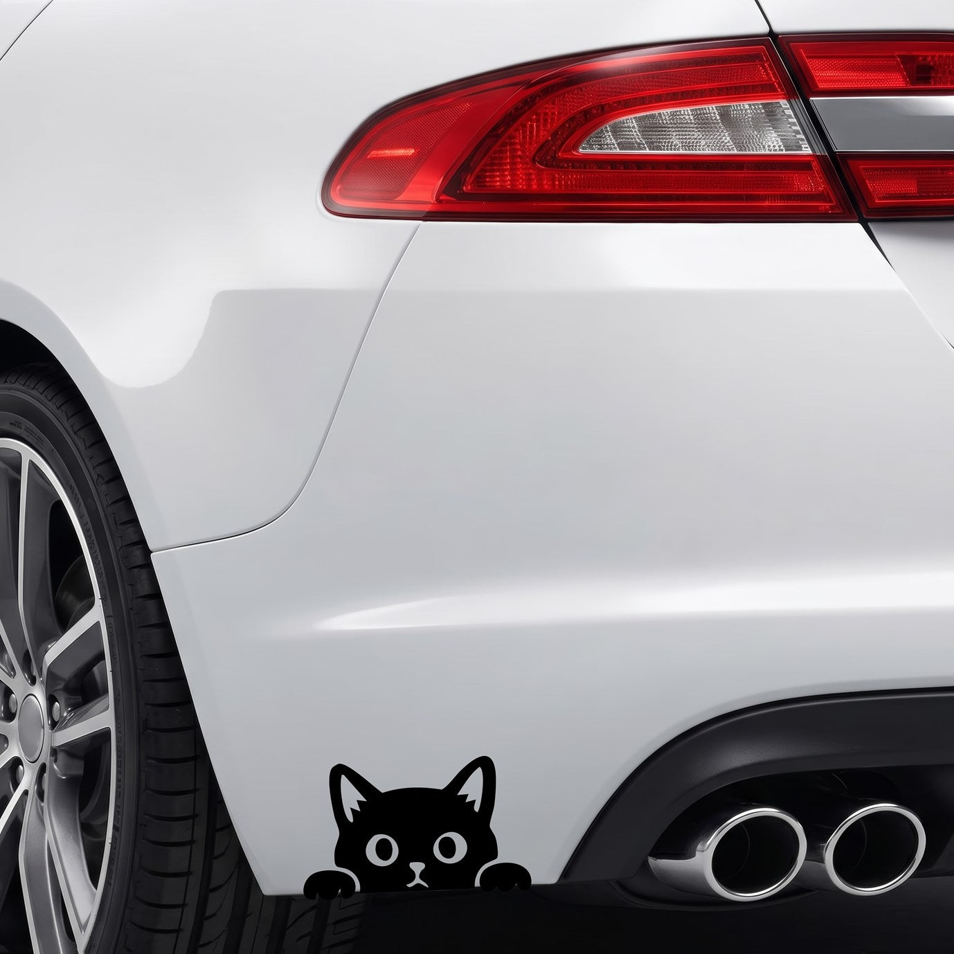 Black peeking cat vinyl sticker applied to a car rear bumper.