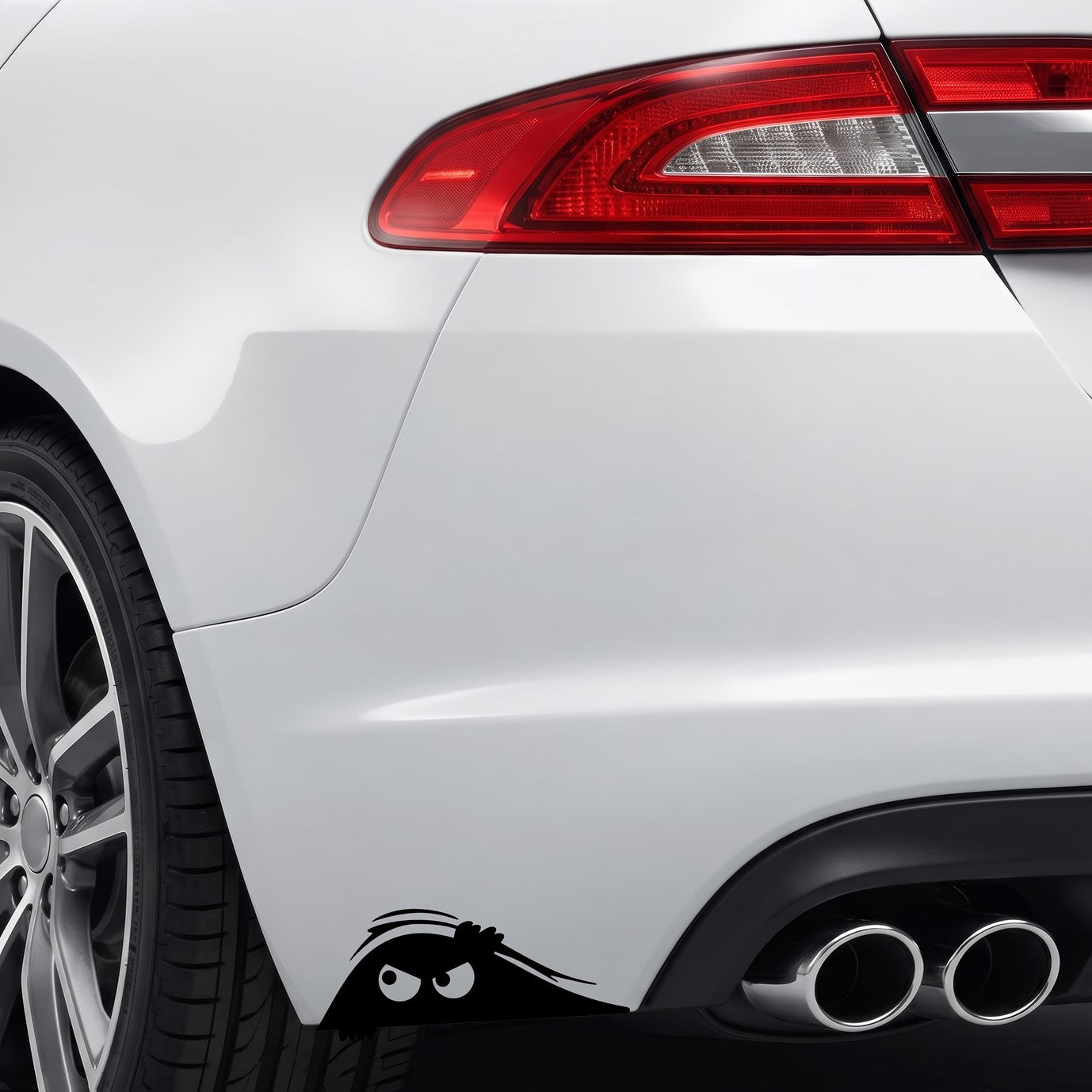 Black peeking monster vinyl sticker applied to a car rear bumper.