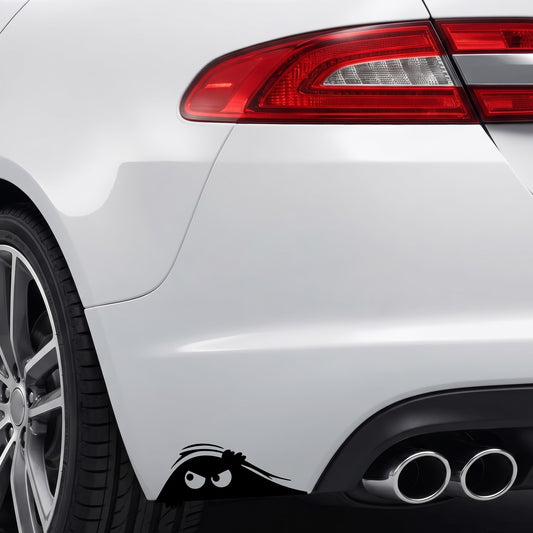Black peeking monster vinyl sticker applied to a car rear bumper.