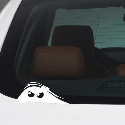 White peeking monster sticker applied to a car window.