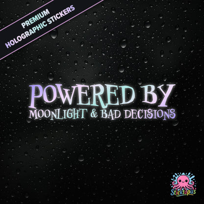 Premium holographic sticker with the phrase “POWERED BY MOONLIGHT & BAD DECISIONS” in bold, pastel-shifting text on a black background with water droplets.