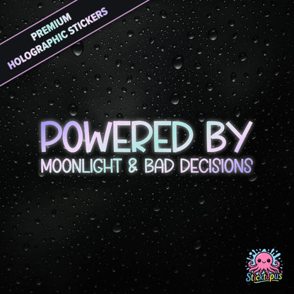 Premium holographic sticker with the phrase “POWERED BY MOONLIGHT & BAD DECISIONS” in bold, pastel-shifting text on a black background with water droplets.