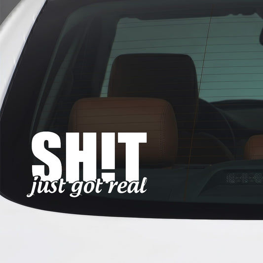 White Shit Just Got Real sticker applied to a car window.