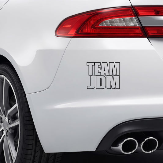 Black Team JDM vinyl sticker applied to a car rear bumper.
