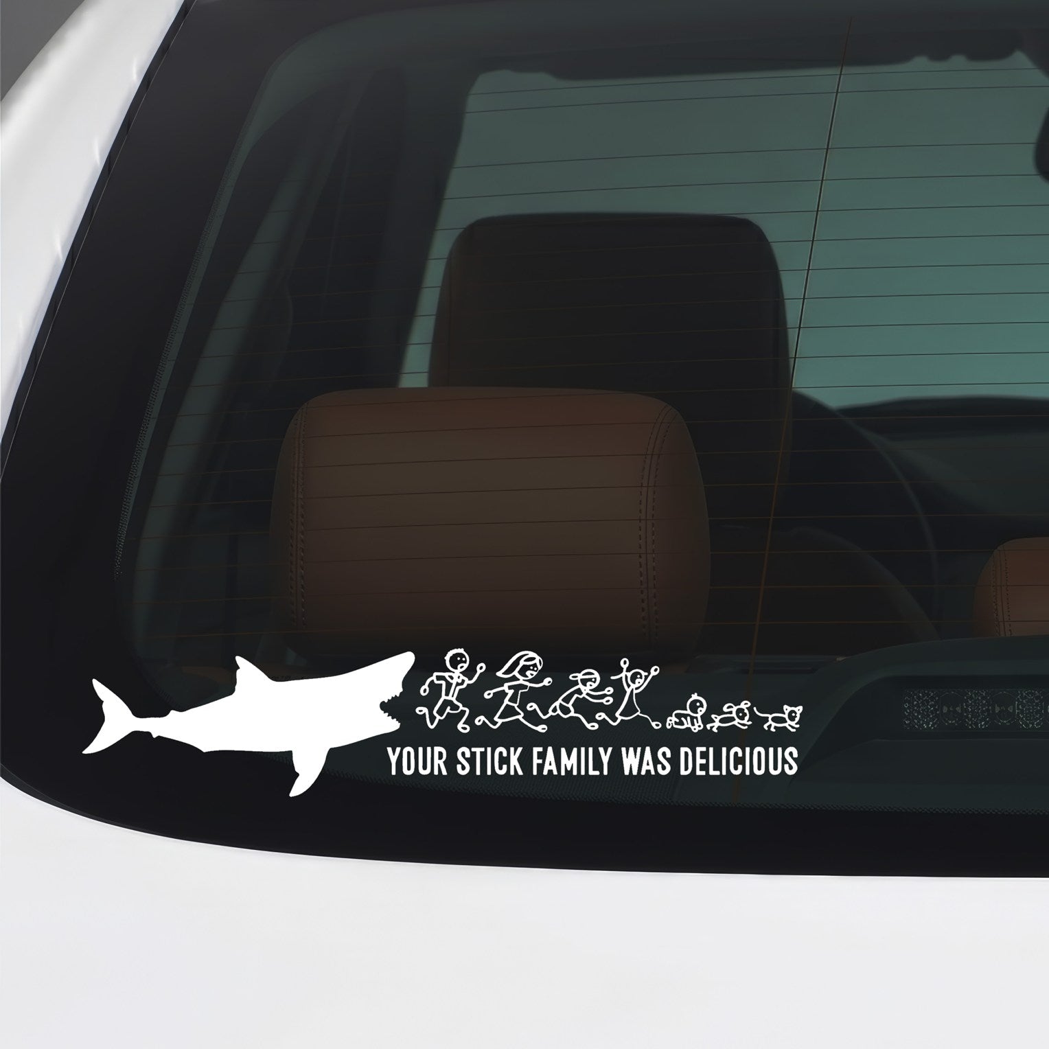 White Your Stick Family Was Delicious shark sticker applied to a car window.